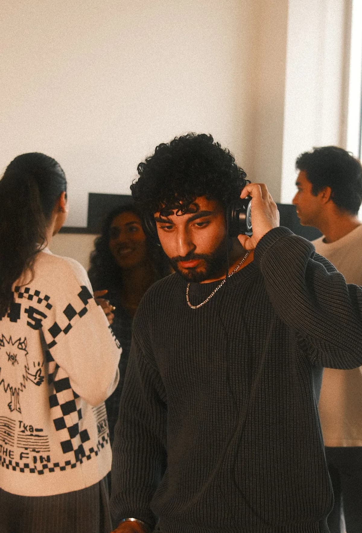 A DJ with a chain and curls on the decks at OTL Sessions vol. 1.